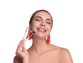 Photo of Beautiful woman with makeup brushes on white background