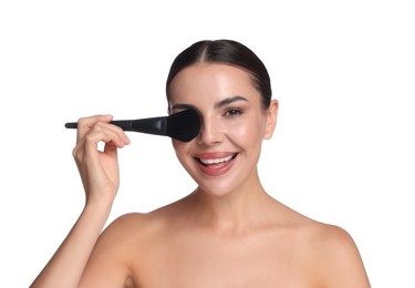 Photo of Beautiful woman applying makeup with brush on white background