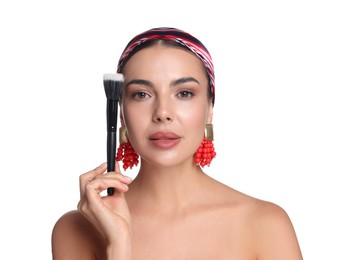 Photo of Beautiful woman with makeup brush on white background