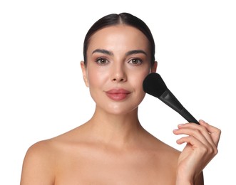 Photo of Beautiful woman applying makeup with brush on white background
