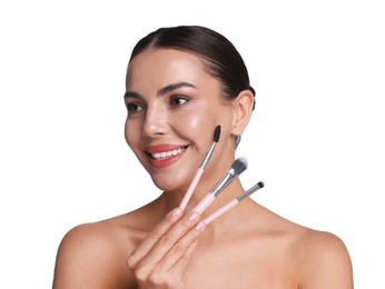 Photo of Beautiful woman with makeup brushes on white background