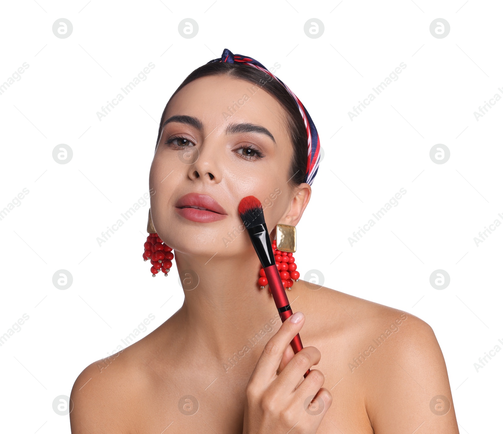 Beautiful woman applying makeup with brush on white background Photo of Beautiful woman applying makeup with brush on white background