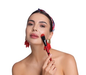 Photo of Beautiful woman applying makeup with brush on white background