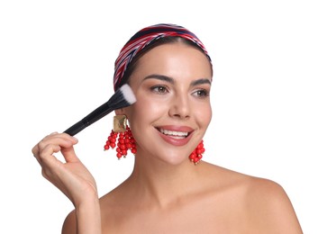 Photo of Beautiful woman applying makeup with brush on white background