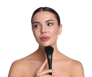 Photo of Beautiful woman applying makeup with brush on white background