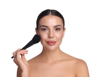 Photo of Beautiful woman applying makeup with brush on white background