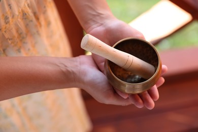 Photo of Woman with singing bowl outdoors, above view