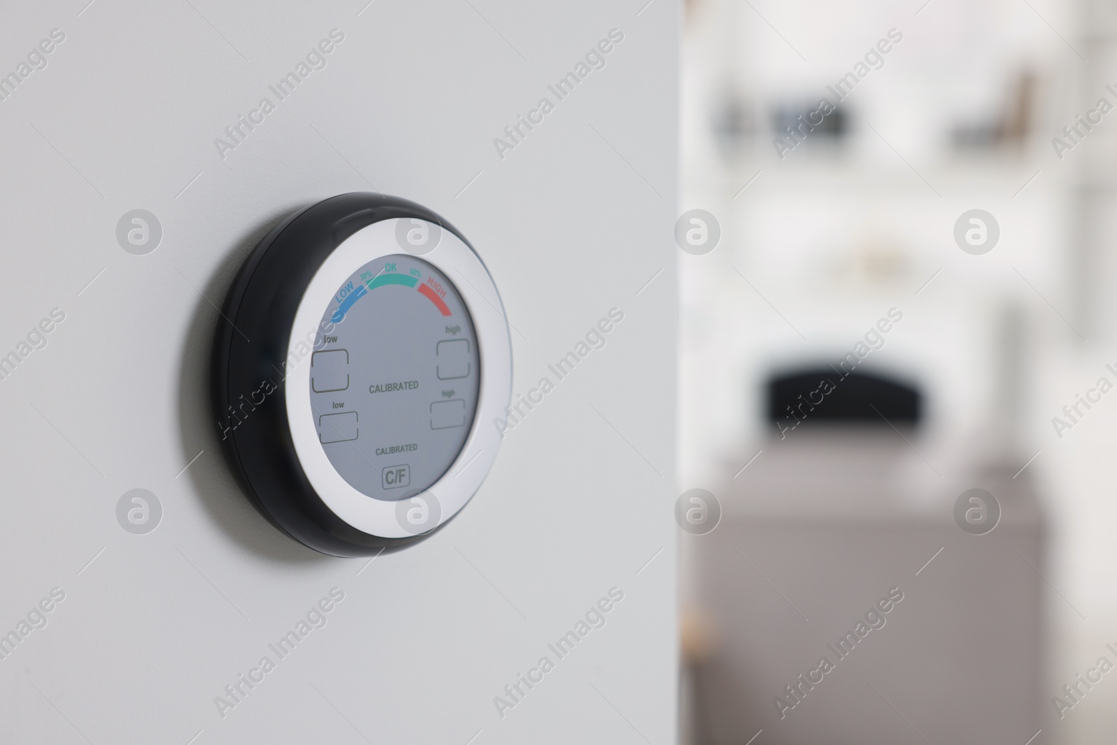 One hygrometer on white wall indoors, space for text. Smart home system Photo of One hygrometer on white wall indoors, space for text. Smart home system