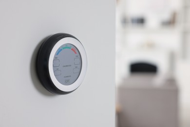 Photo of One hygrometer on white wall indoors, space for text. Smart home system