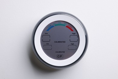 Photo of One hygrometer on white wall. Smart home system