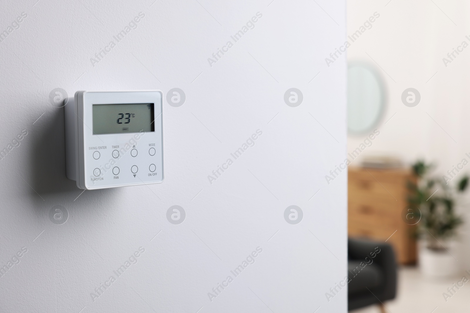 One thermostat on white wall indoors, space for text. Smart home system Photo of One thermostat on white wall indoors, space for text. Smart home system