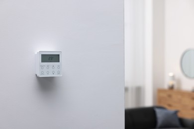 Photo of One thermostat on white wall indoors, space for text. Smart home system