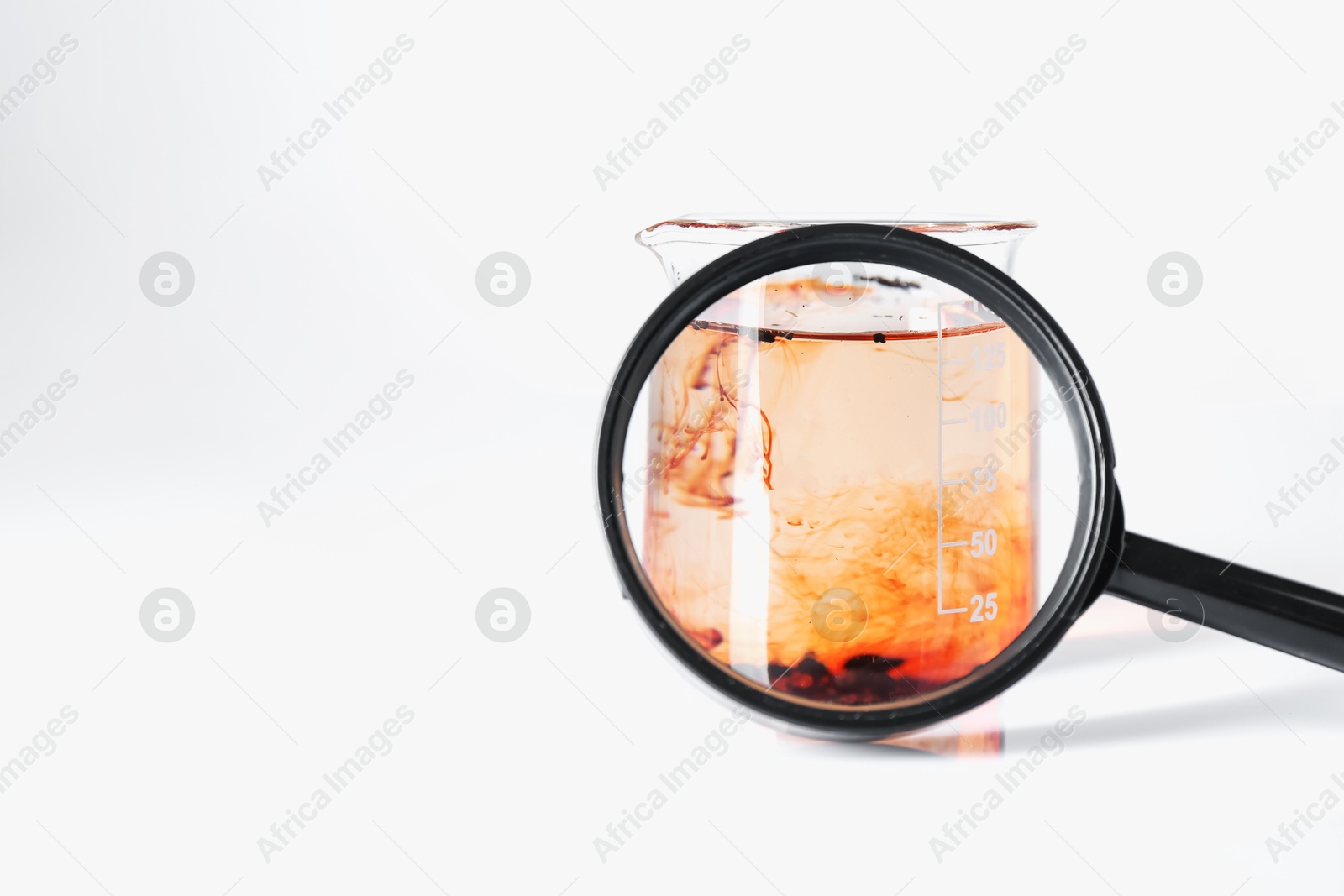 Beaker with dirty water and magnifying glass on white background. Space for text Photo of Beaker with dirty water and magnifying glass on white background. Space for text