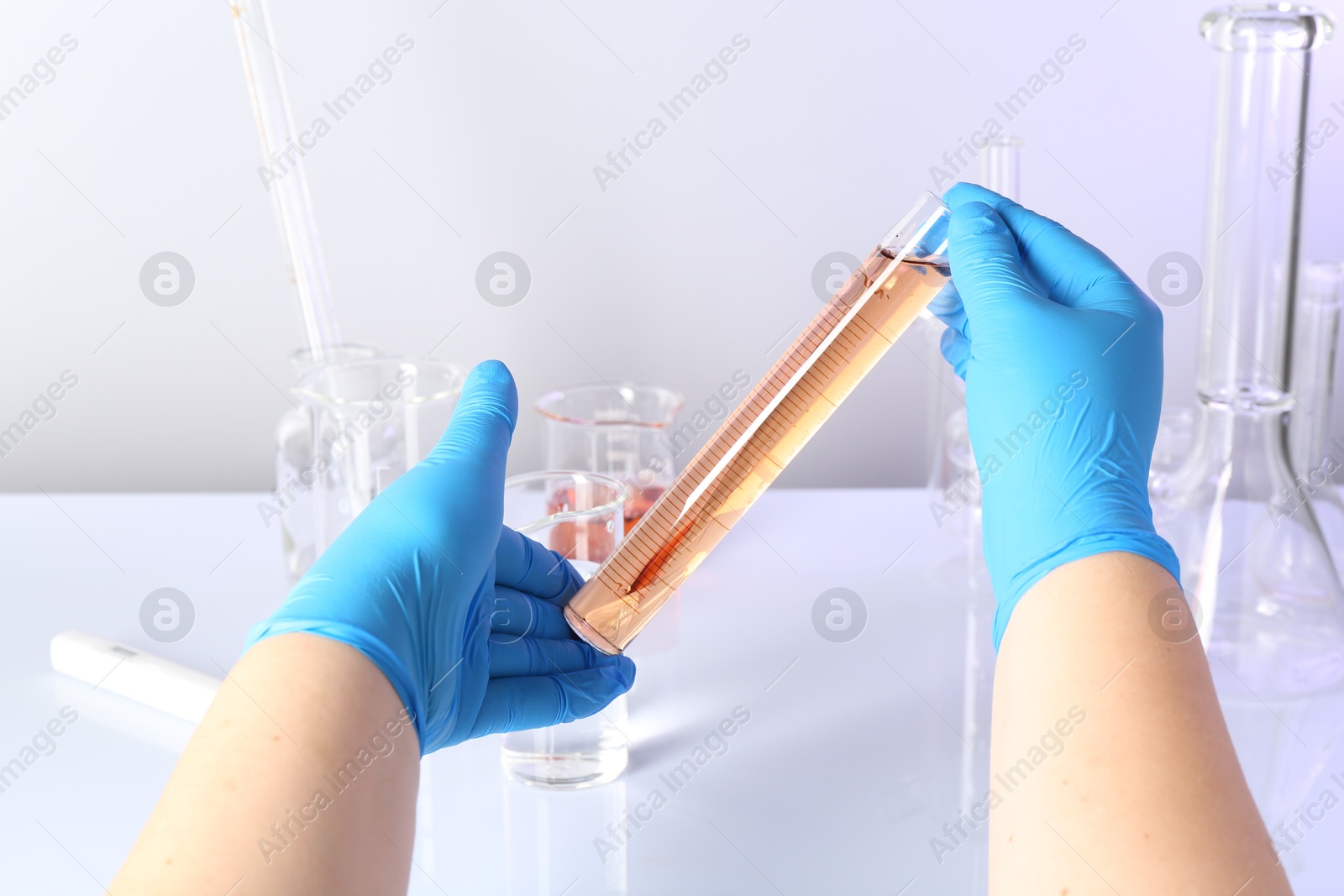 Scientist testing dirty water at white table, closeup Photo of Scientist testing dirty water at white table, closeup