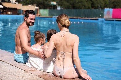 Photo of Family at poolside outdoors on sunny day