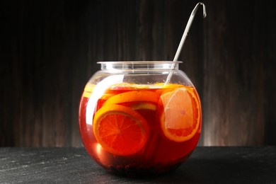 Photo of Fruity punch on black table. Refreshing drink