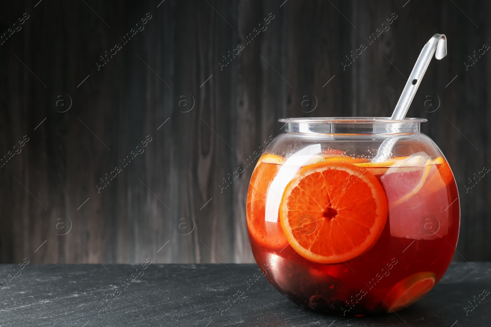 Fruity punch on black table, space for text. Refreshing drink Photo of Fruity punch on black table, space for text. Refreshing drink