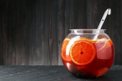 Photo of Fruity punch on black table, space for text. Refreshing drink