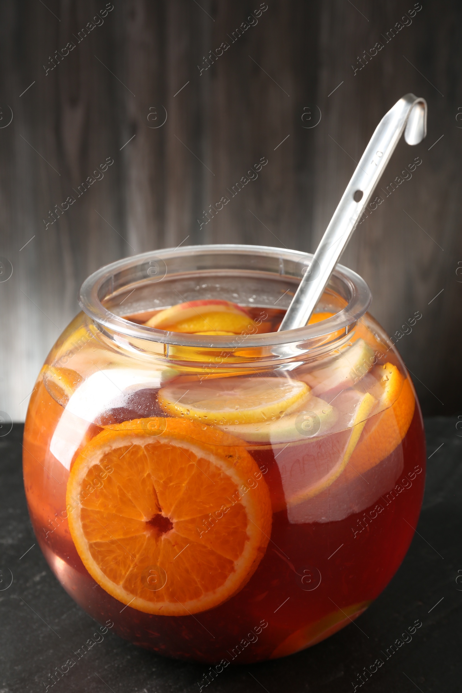 Fruity punch on black table. Refreshing drink Photo of Fruity punch on black table. Refreshing drink