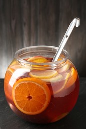 Photo of Fruity punch on black table. Refreshing drink