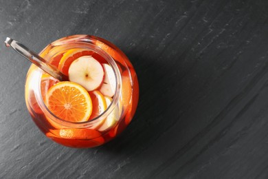 Photo of Fruity punch on black table, top view with space for text. Refreshing drink