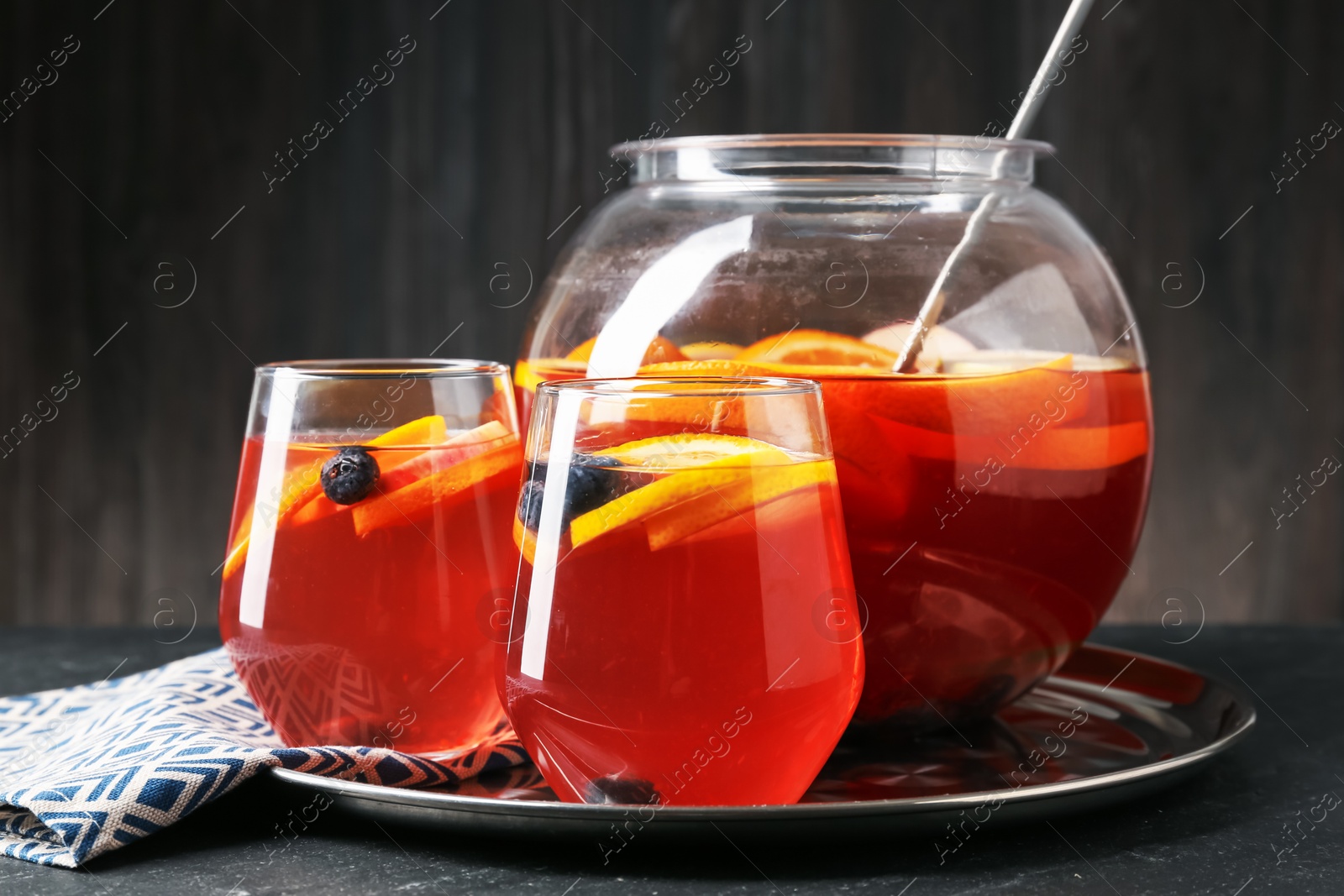 Fruity punch on black table, closeup. Refreshing drink Photo of Fruity punch on black table, closeup. Refreshing drink