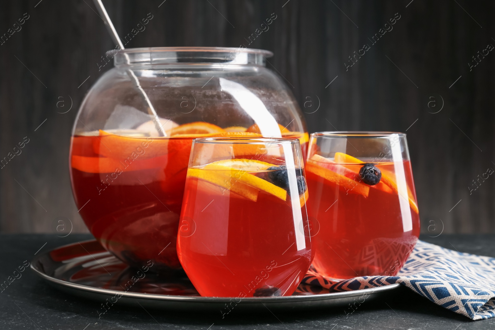 Fruity punch on black table, closeup. Refreshing drink Photo of Fruity punch on black table, closeup. Refreshing drink