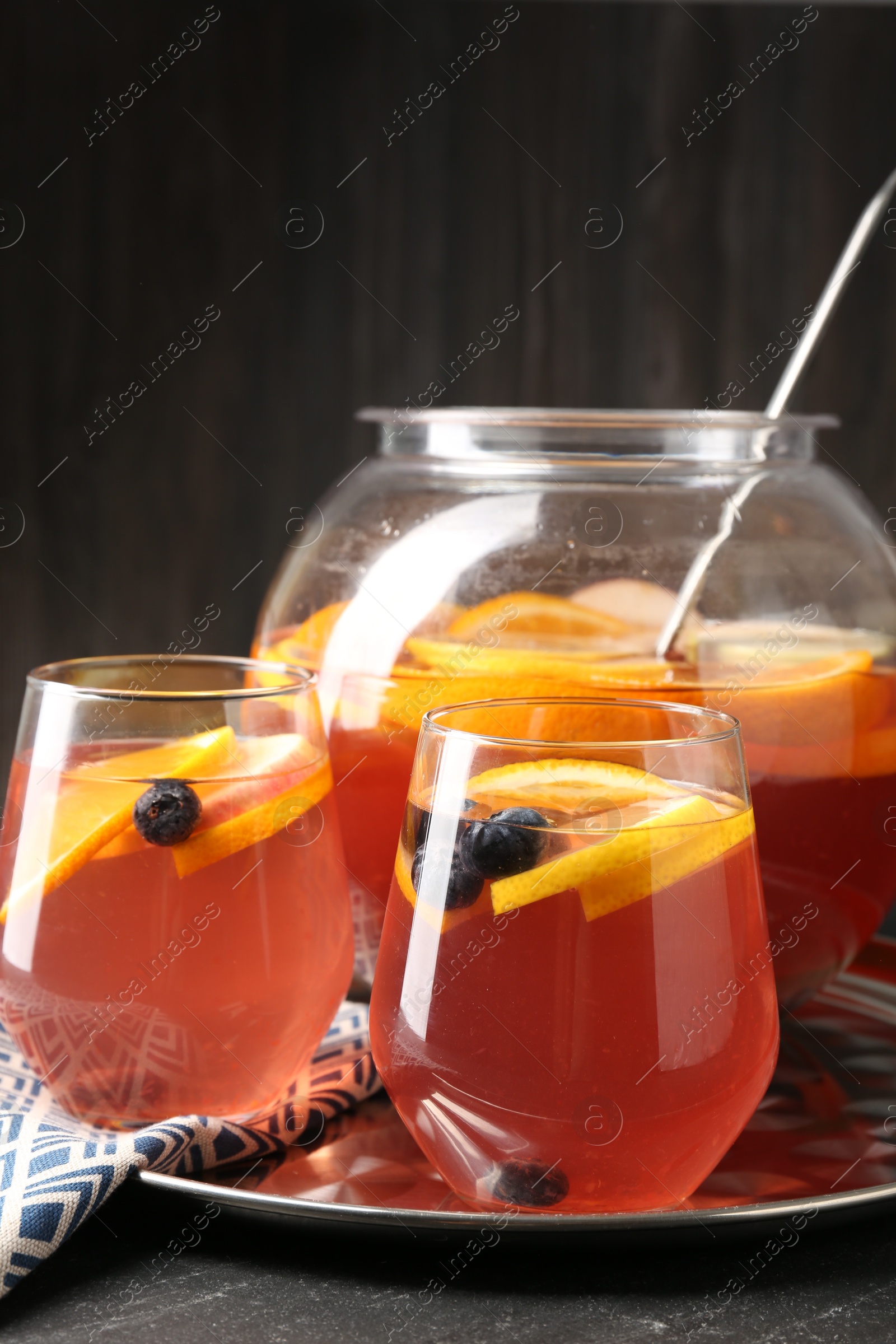 Fruity punch on black table, closeup. Refreshing drink Photo of Fruity punch on black table, closeup. Refreshing drink