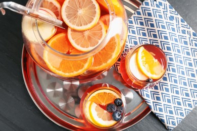 Photo of Fruity punch on black table, top view. Refreshing drink