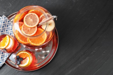 Photo of Fruity punch on black table, top view with space for text. Refreshing drink