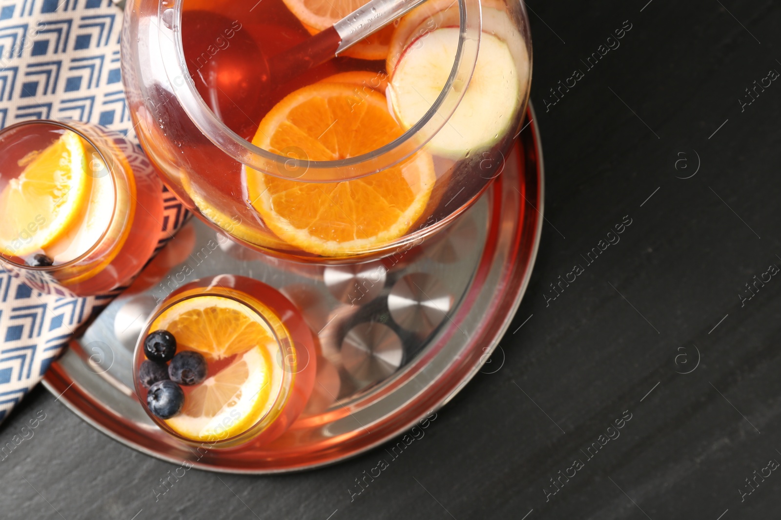 Fruity punch on black table, top view. Refreshing drink Photo of Fruity punch on black table, top view. Refreshing drink