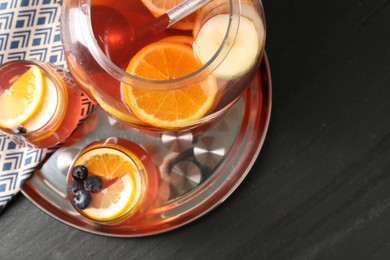 Photo of Fruity punch on black table, top view. Refreshing drink