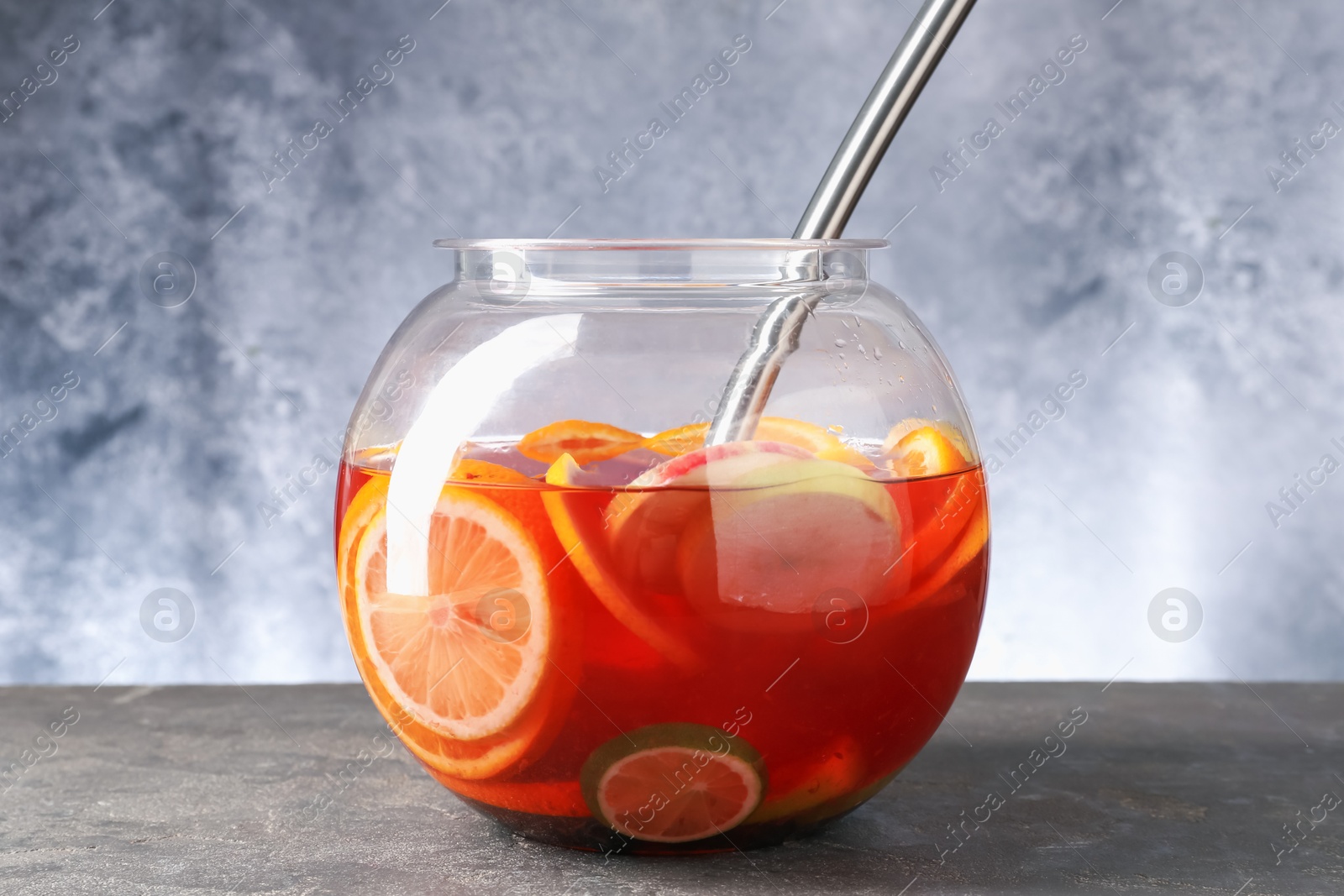 Fruity punch on grey table. Refreshing drink Photo of Fruity punch on grey table. Refreshing drink