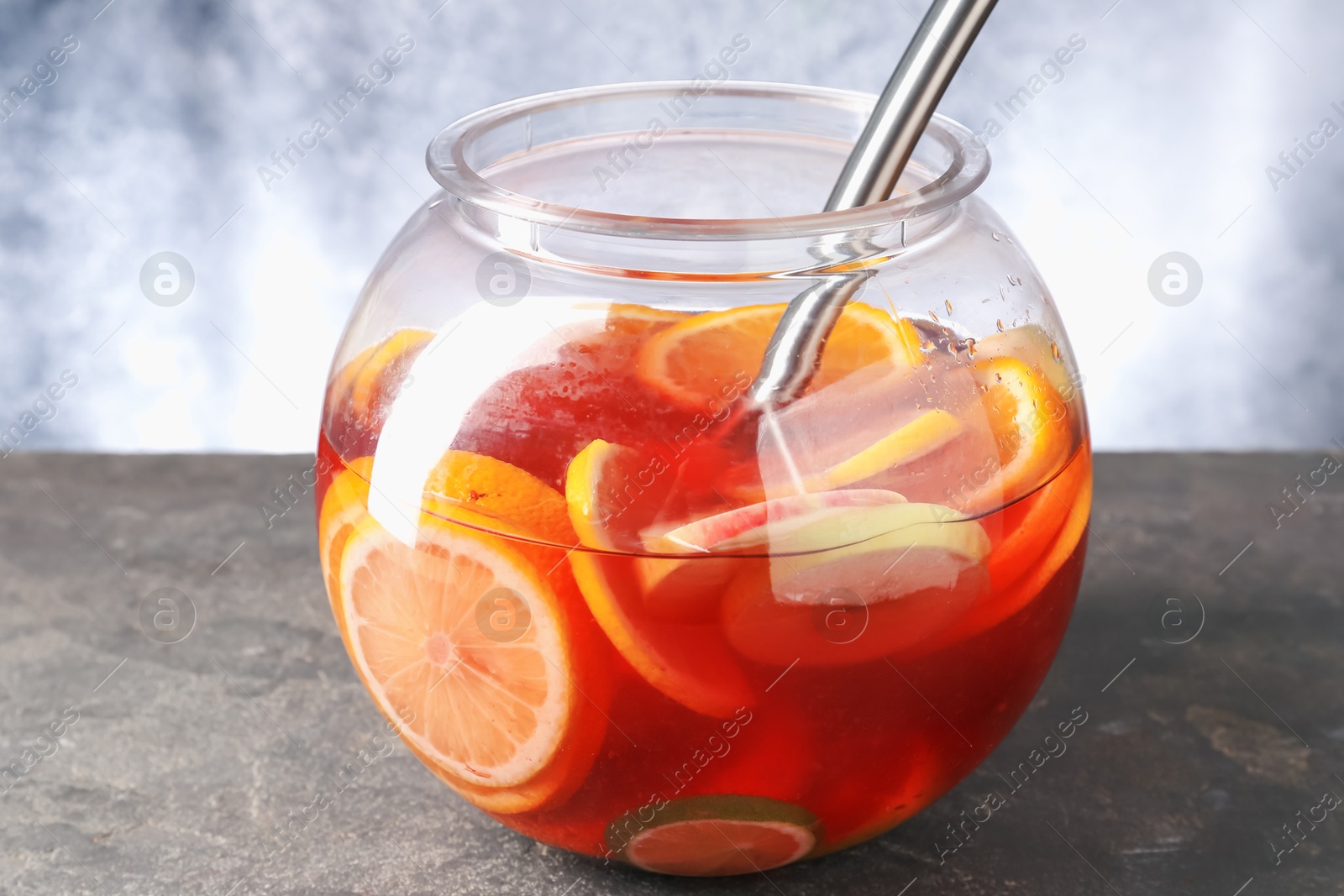 Fruity punch on grey table, closeup. Refreshing drink Photo of Fruity punch on grey table, closeup. Refreshing drink