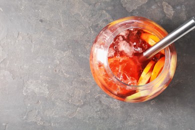 Photo of Fruity punch on grey table, top view with space for text. Refreshing drink