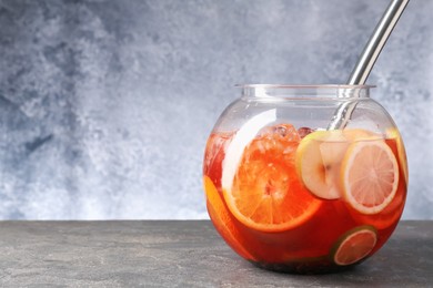 Photo of Fruity punch on grey table, space for text. Refreshing drink