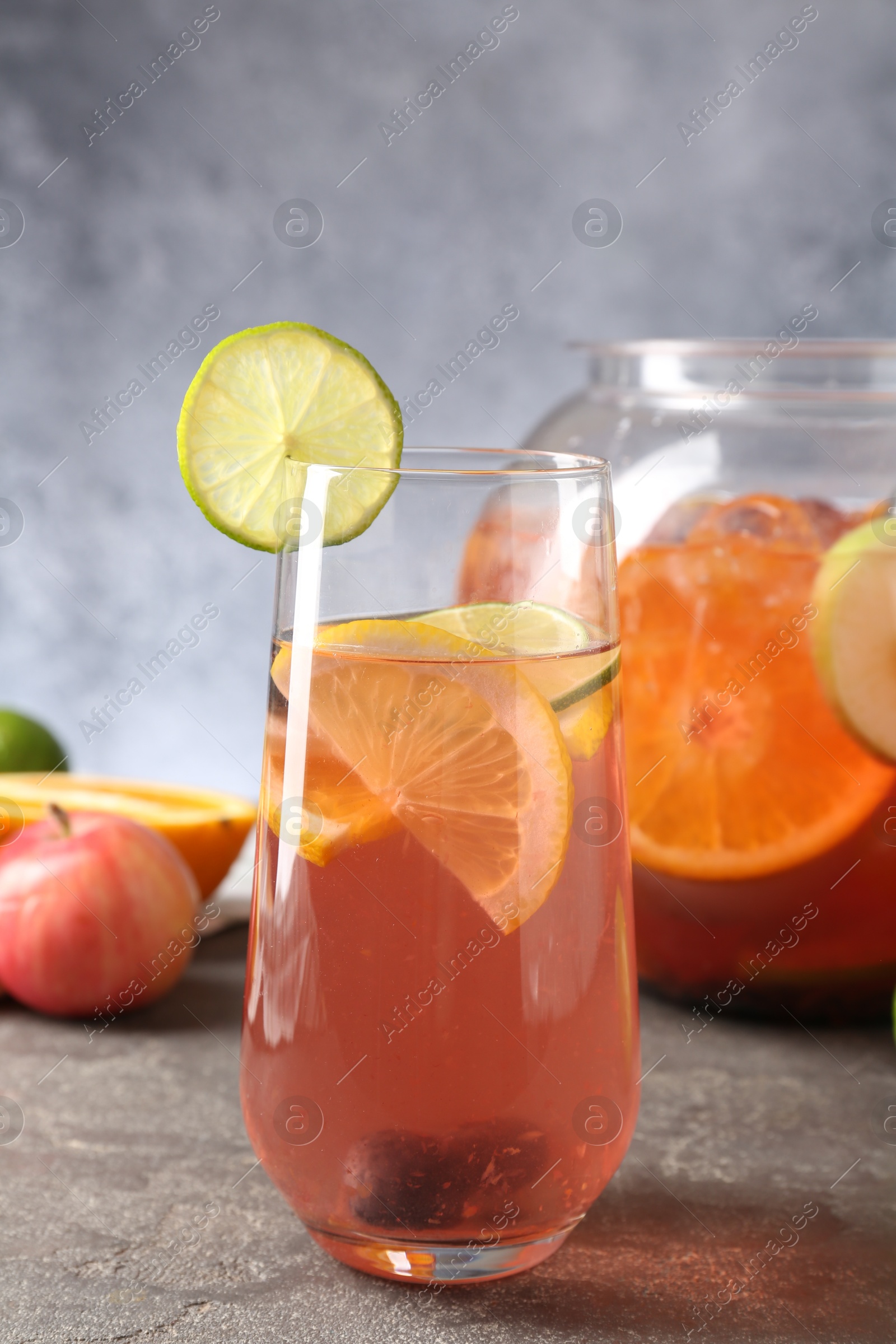 Punch and fresh fruits on grey table. Refreshing drink Photo of Punch and fresh fruits on grey table. Refreshing drink