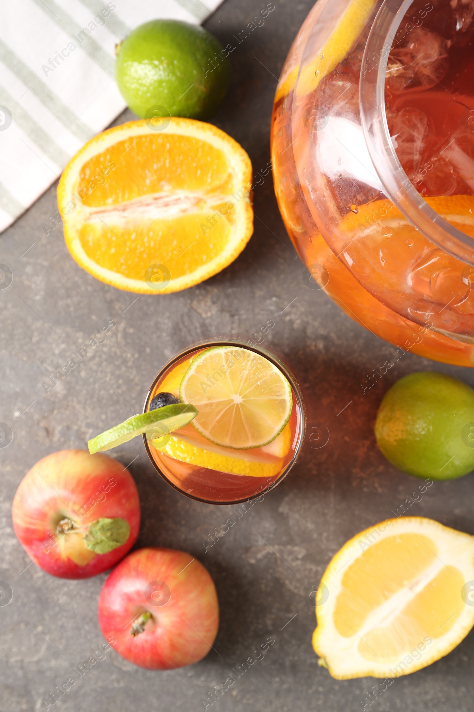 Punch and fresh fruits on grey table, flat lay. Refreshing drink Photo of Punch and fresh fruits on grey table, flat lay. Refreshing drink
