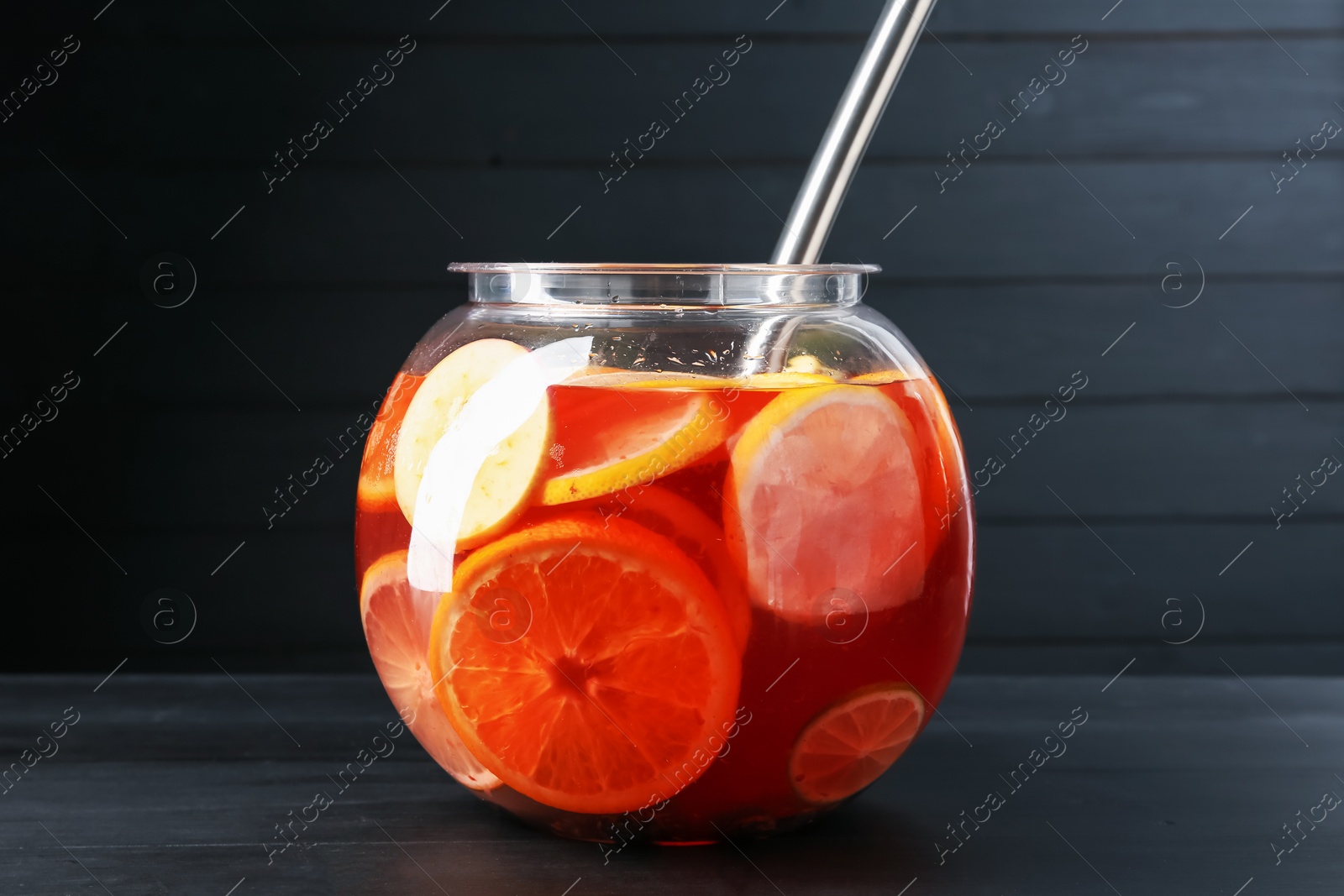 Fruity punch on black wooden table. Refreshing drink Photo of Fruity punch on black wooden table. Refreshing drink