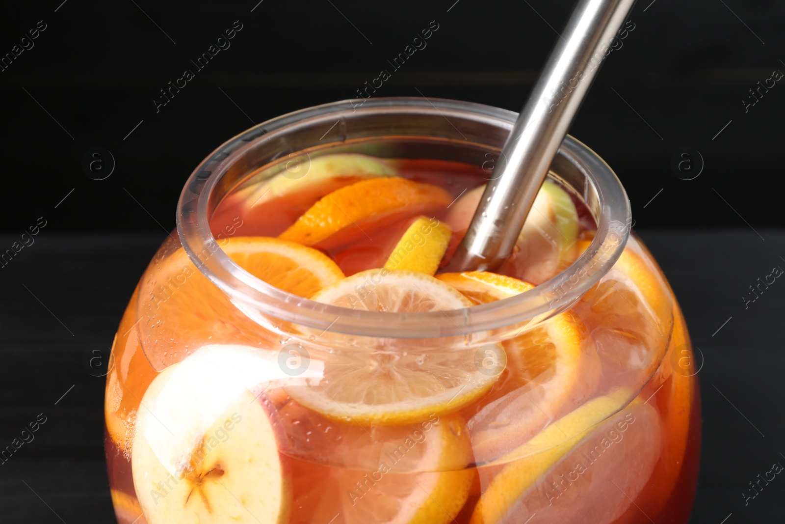 Fruity punch on black table. Refreshing drink Photo of Fruity punch on black table. Refreshing drink