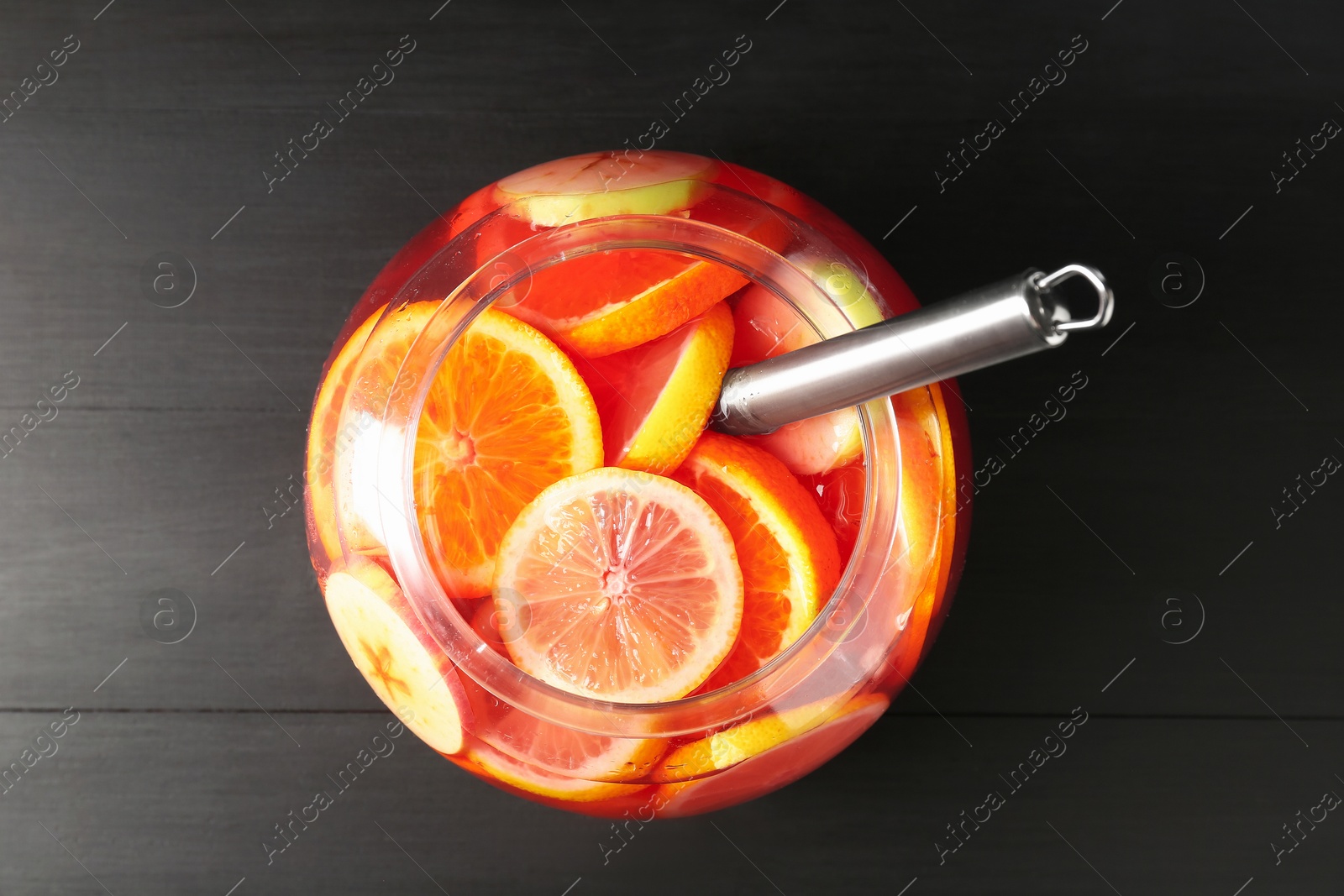 Fruity punch on black wooden table, top view. Refreshing drink Photo of Fruity punch on black wooden table, top view. Refreshing drink