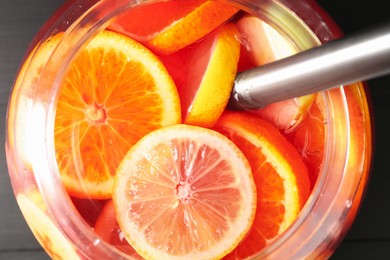 Photo of Fruity punch on black table. Refreshing drink