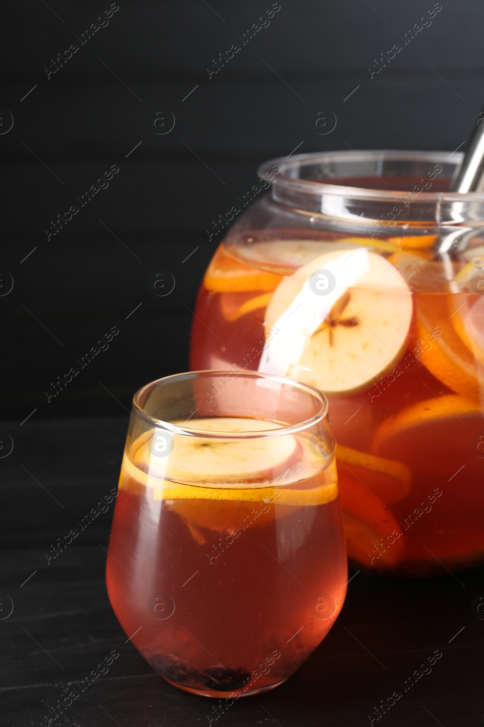 Fruity punch on black wooden table, closeup. Refreshing drink Photo of Fruity punch on black wooden table, closeup. Refreshing drink