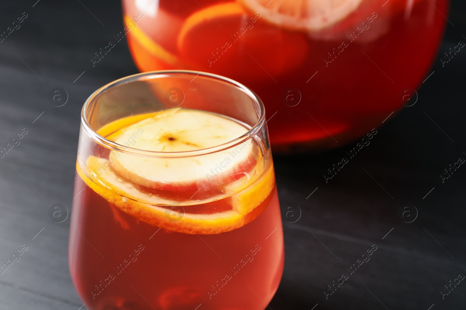 Fruity punch on black wooden table, closeup. Refreshing drink Photo of Fruity punch on black wooden table, closeup. Refreshing drink