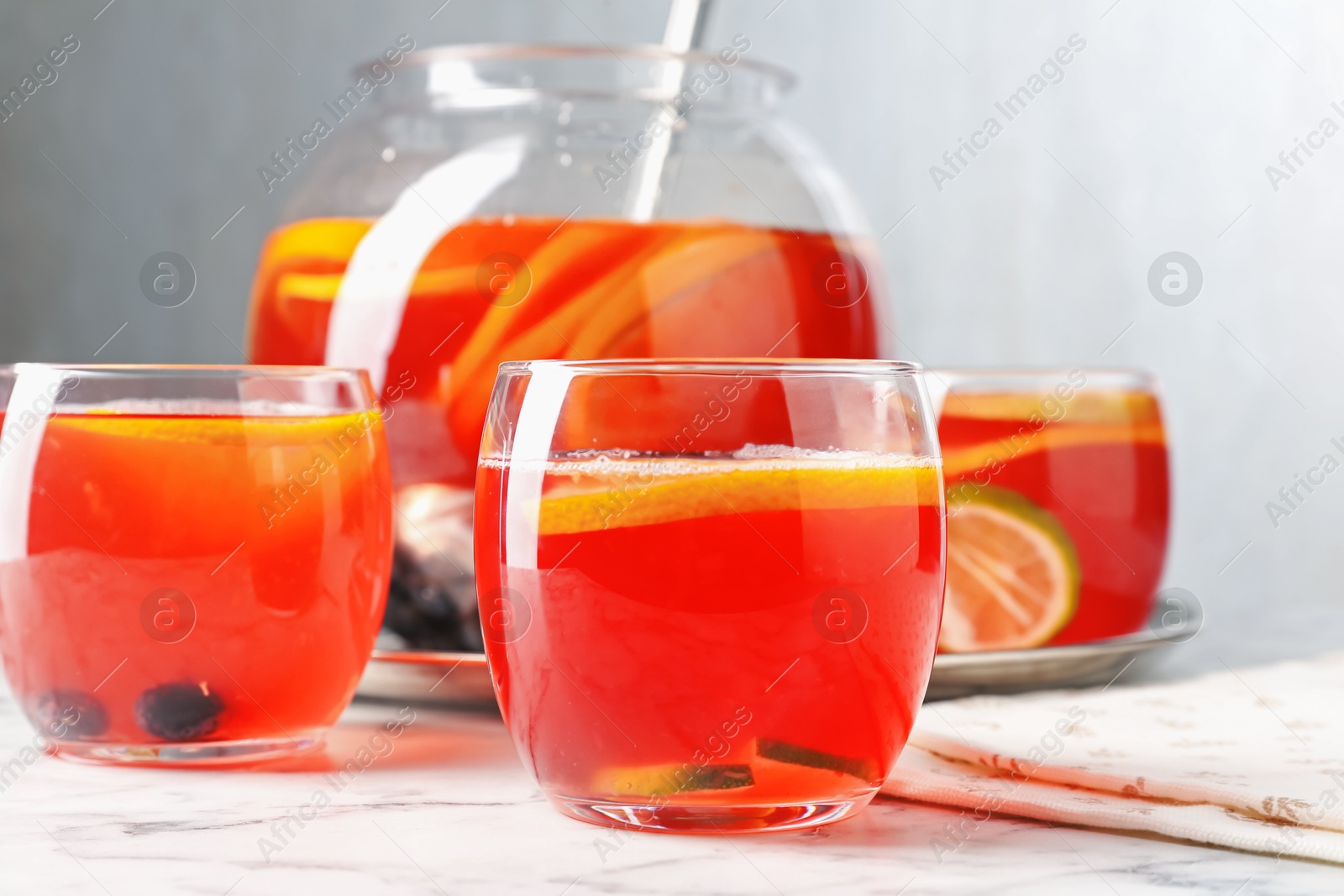 Fruity punch on white marble table, closeup. Refreshing drink Photo of Fruity punch on white marble table, closeup. Refreshing drink