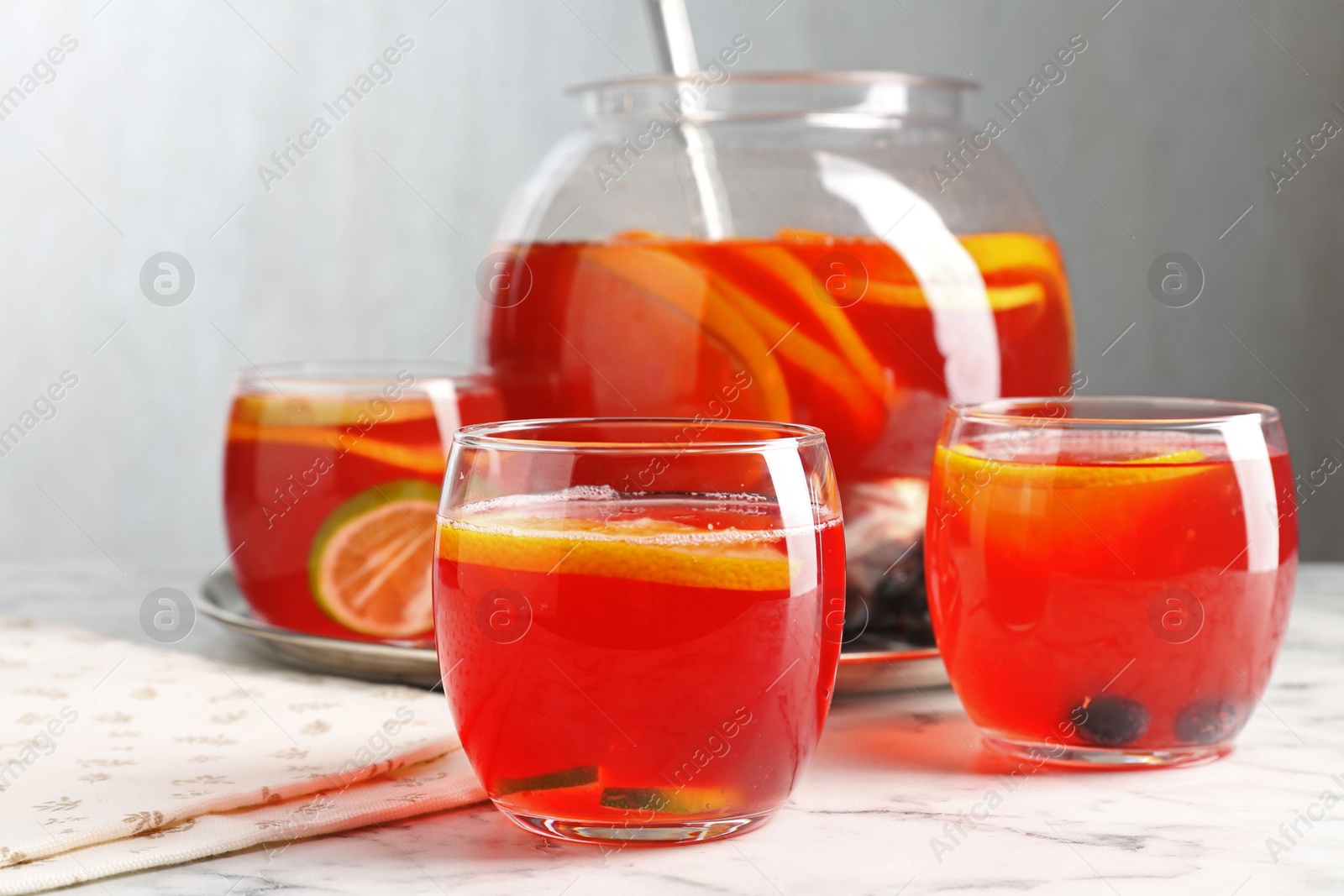 Fruity punch on white marble table, closeup. Refreshing drink Photo of Fruity punch on white marble table, closeup. Refreshing drink
