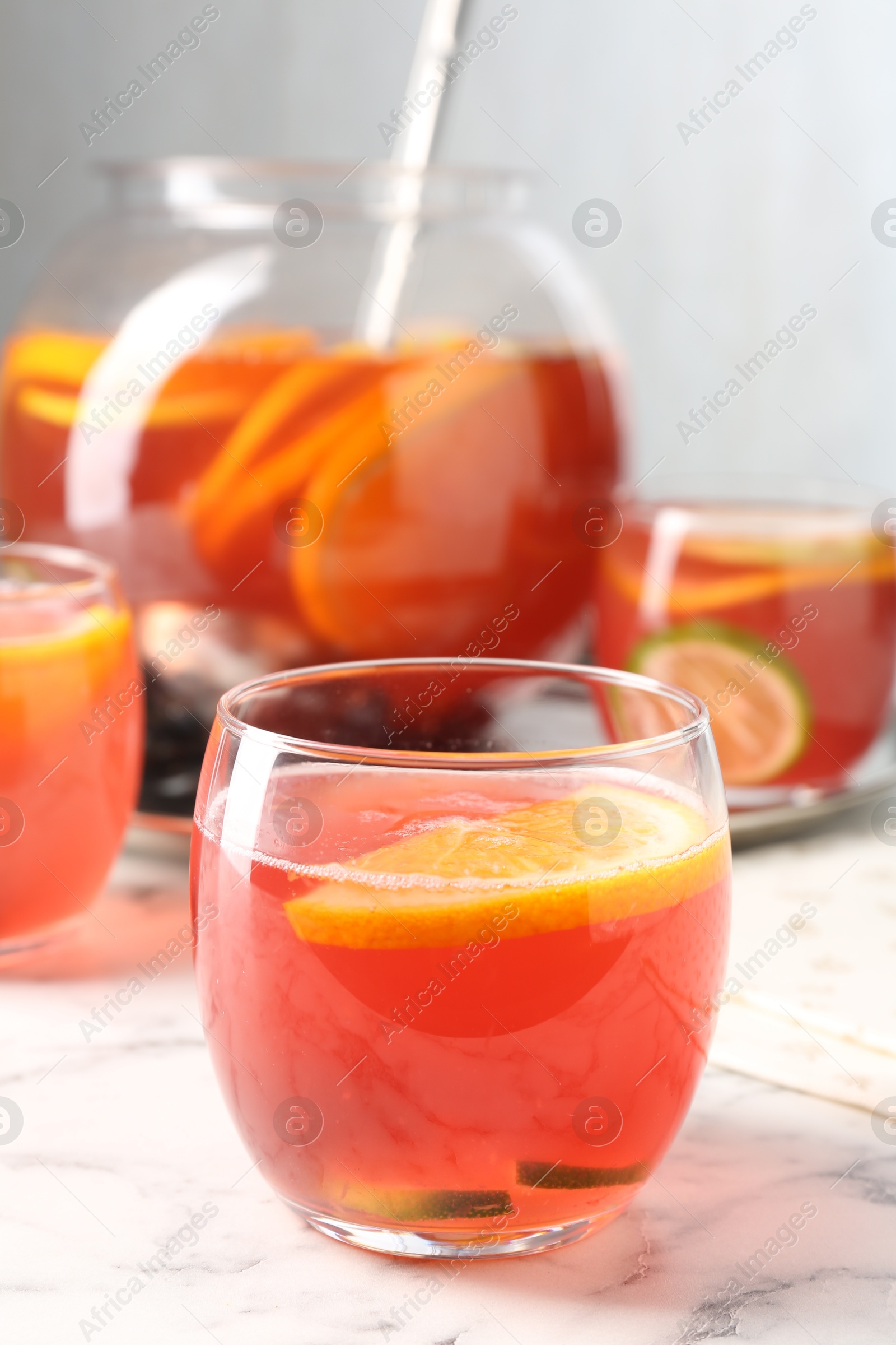 Fruity punch on white marble table, closeup. Refreshing drink Photo of Fruity punch on white marble table, closeup. Refreshing drink
