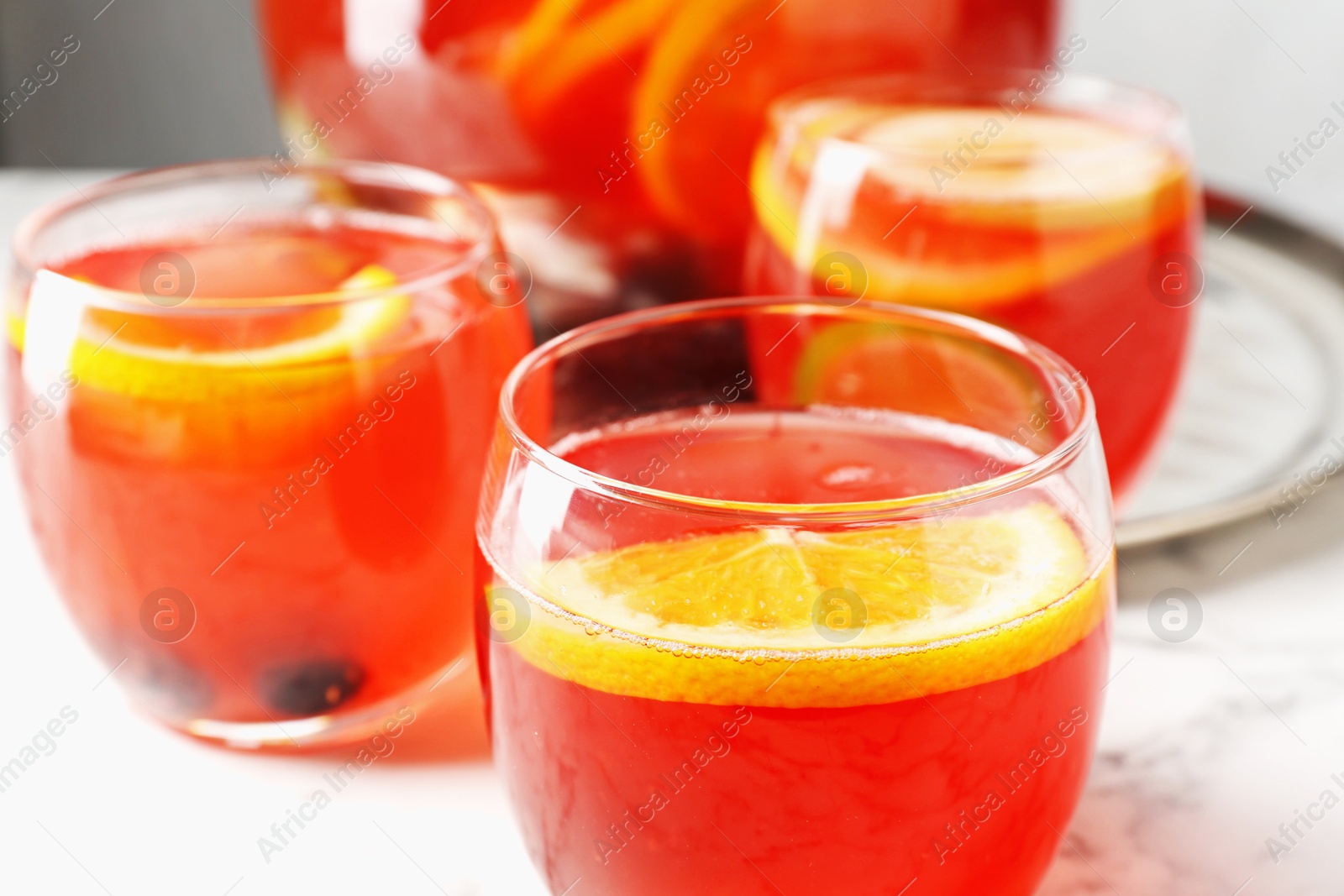 Fruity punch on white marble table, closeup. Refreshing drink Photo of Fruity punch on white marble table, closeup. Refreshing drink