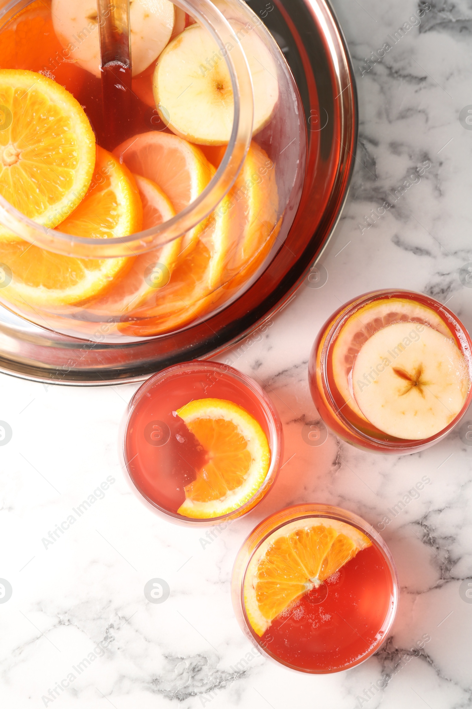Fruity punch on white marble table, flat lay. Refreshing drink Photo of Fruity punch on white marble table, flat lay. Refreshing drink