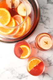 Photo of Fruity punch on white marble table, flat lay. Refreshing drink